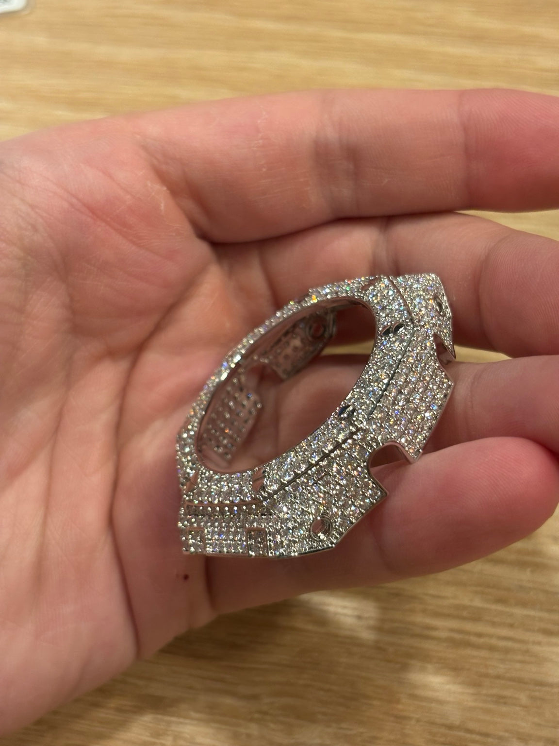 Moissanite GA-2100 bezel cover held at a side angle