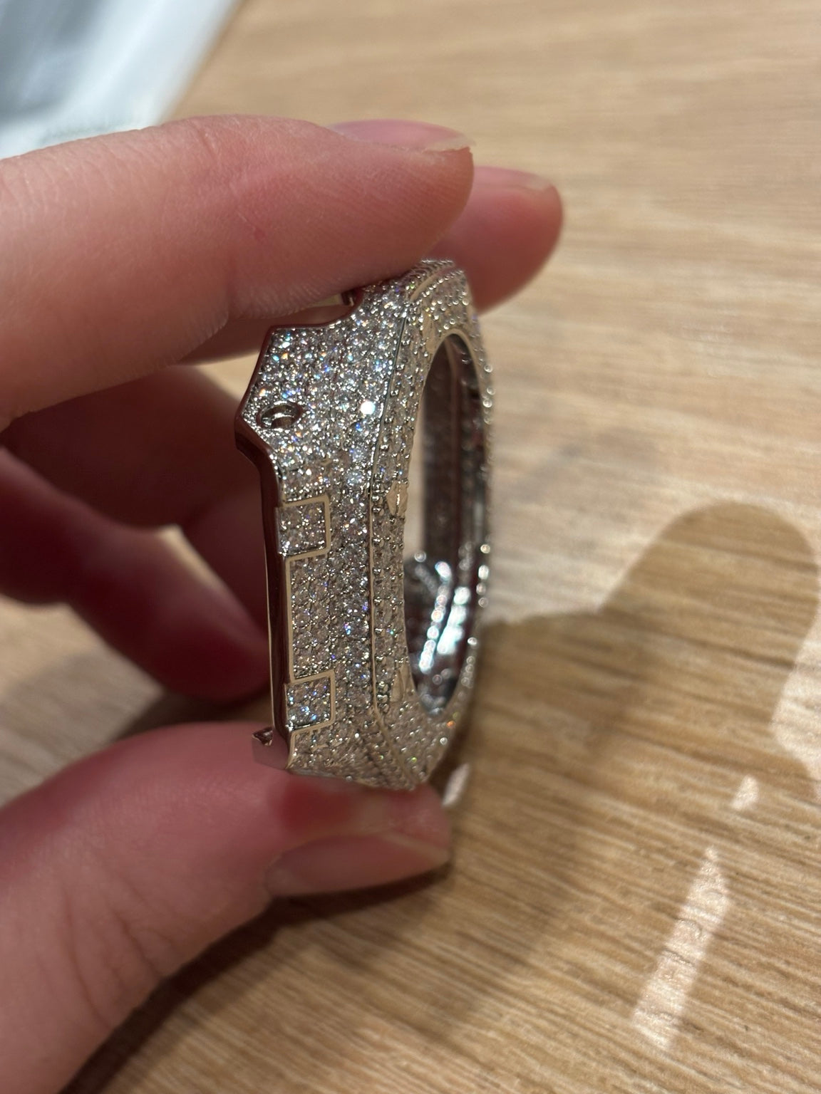 Close-up side detail of the moissanite stone setting on the bezel cover