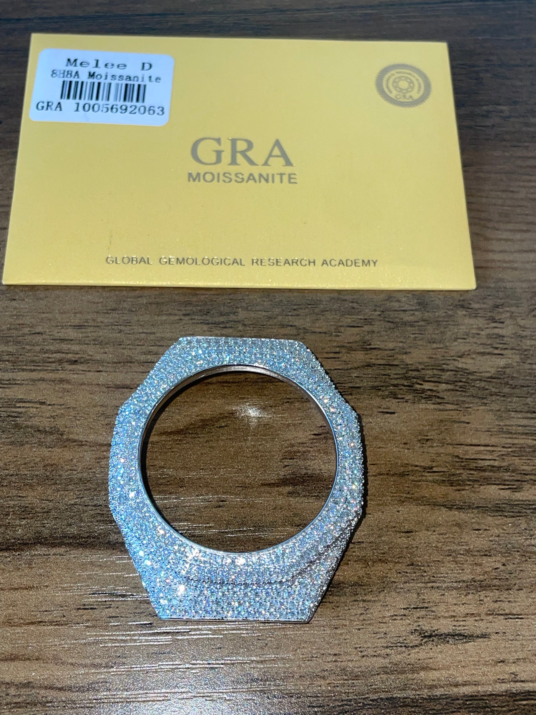 GA2100 moissanite bezel cover displayed with GRA Moissanite card