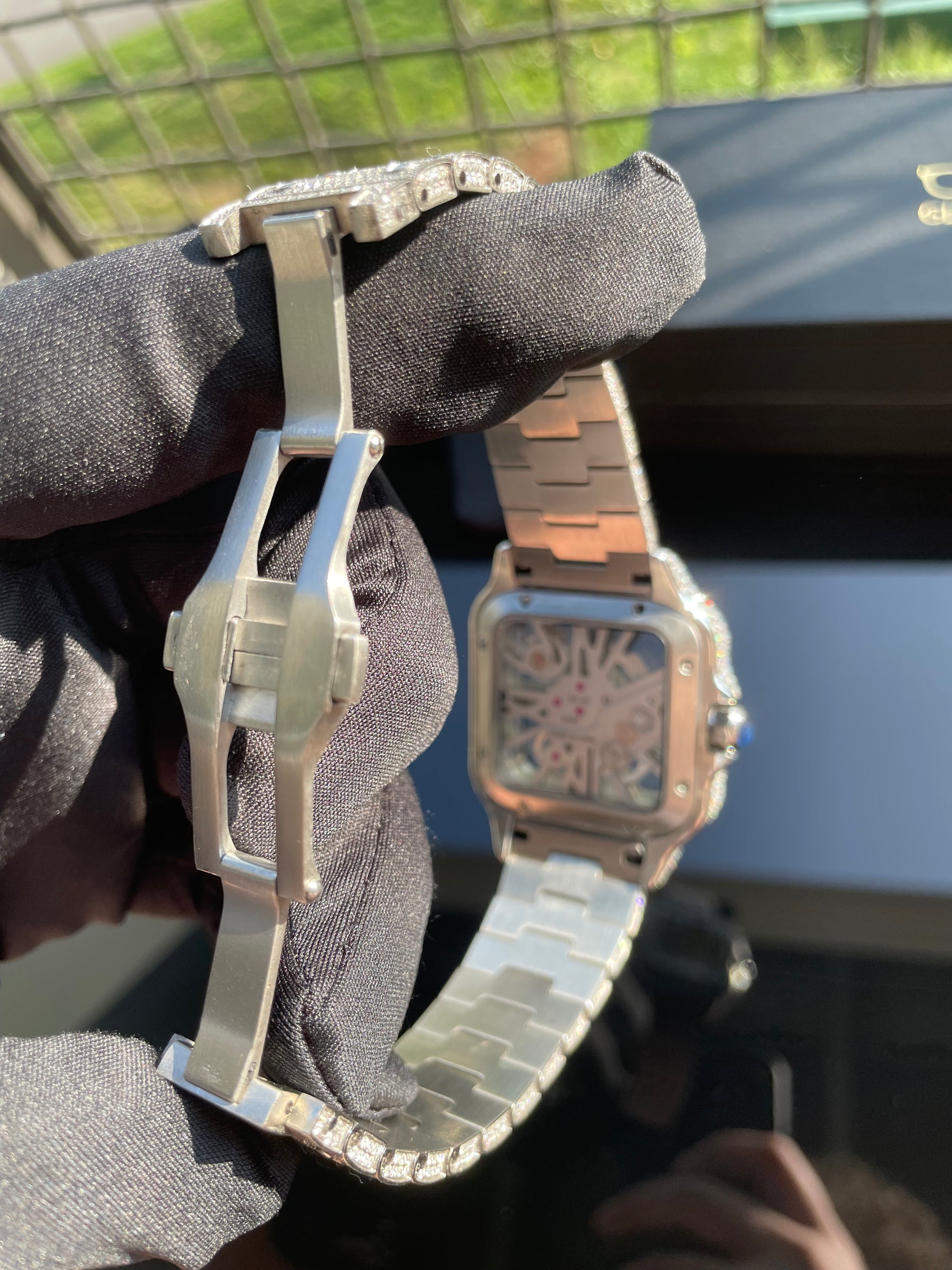 Deployant clasp and silver-tone bracelet on the moissanite watch