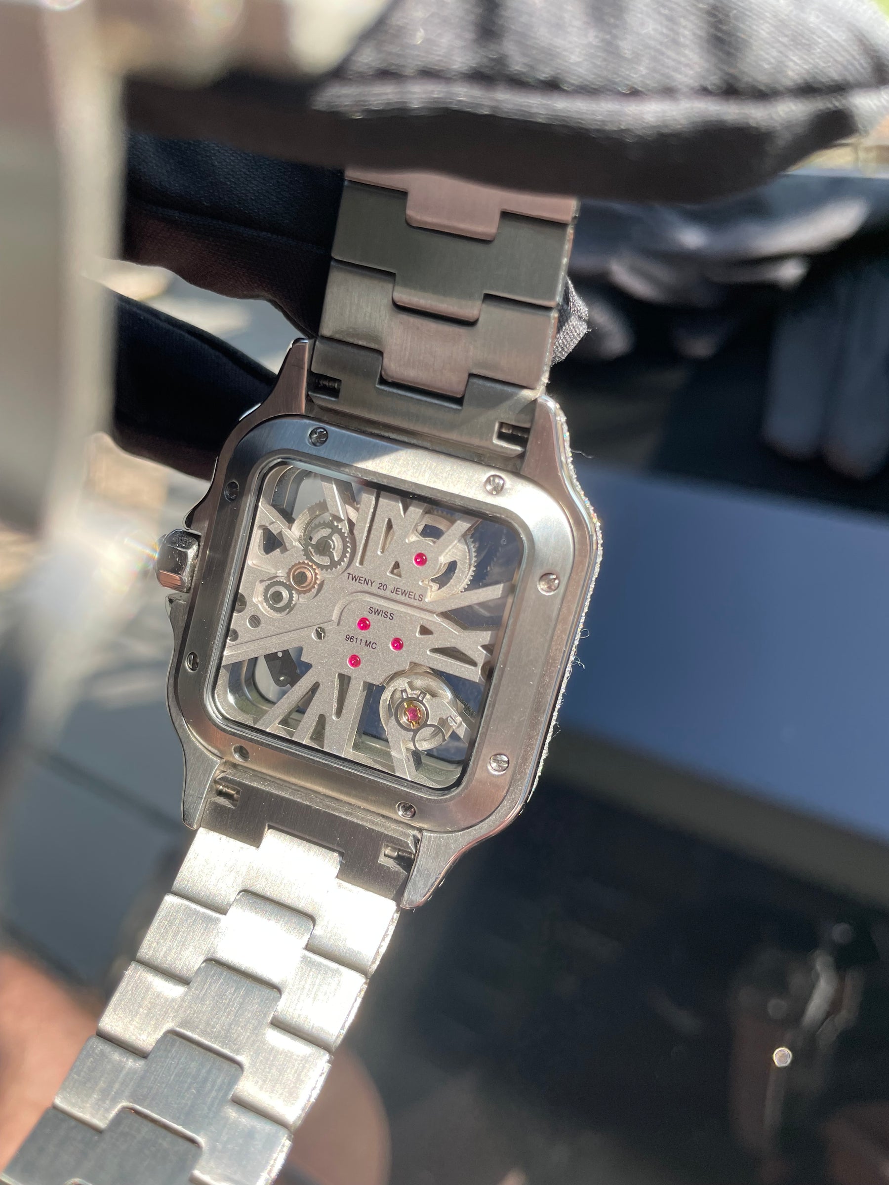 Exhibition-style watch caseback with visible internal components and markings