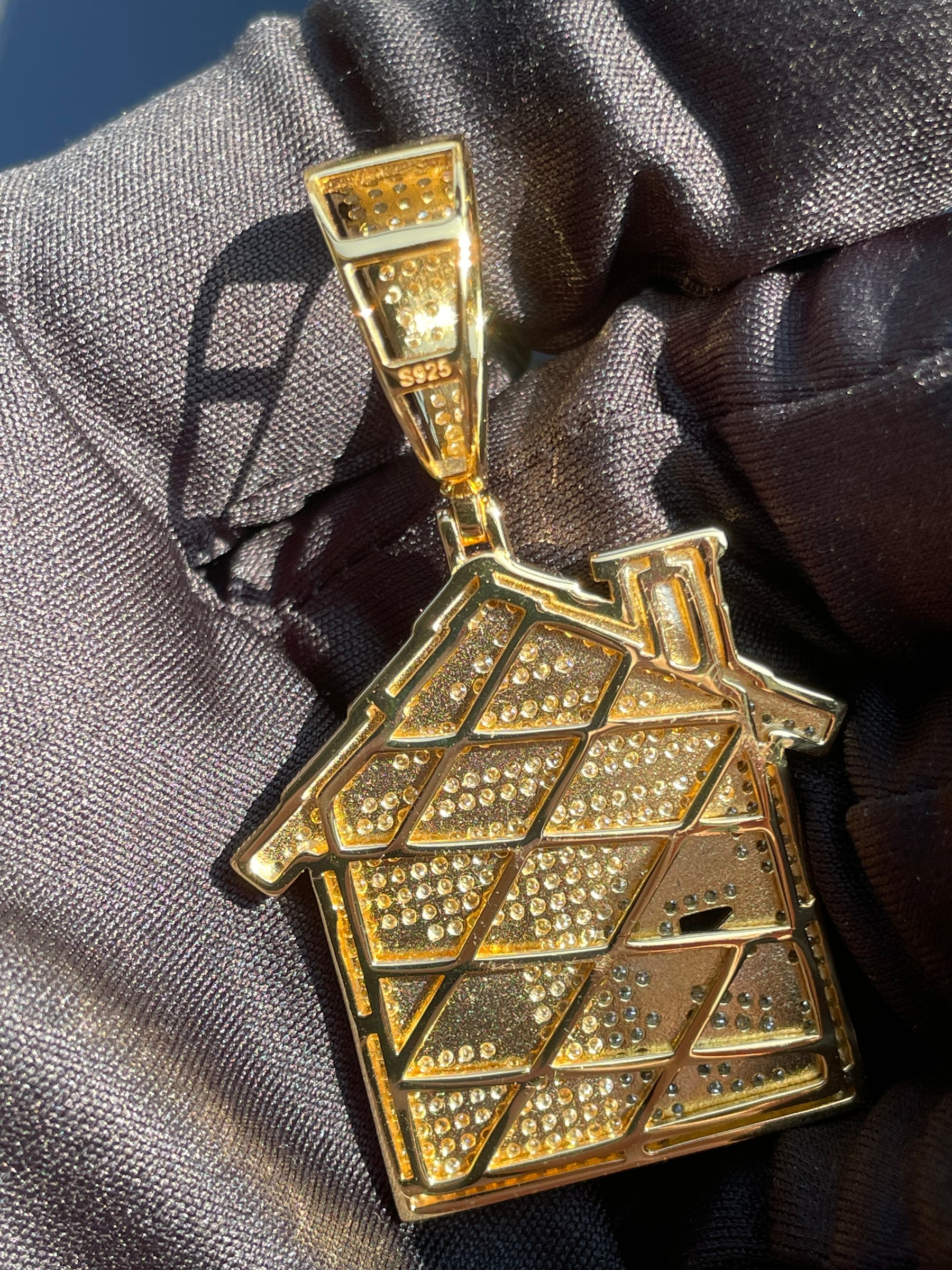 Back of the S925 trap house pendant showing open stone settings and the S925 stamp