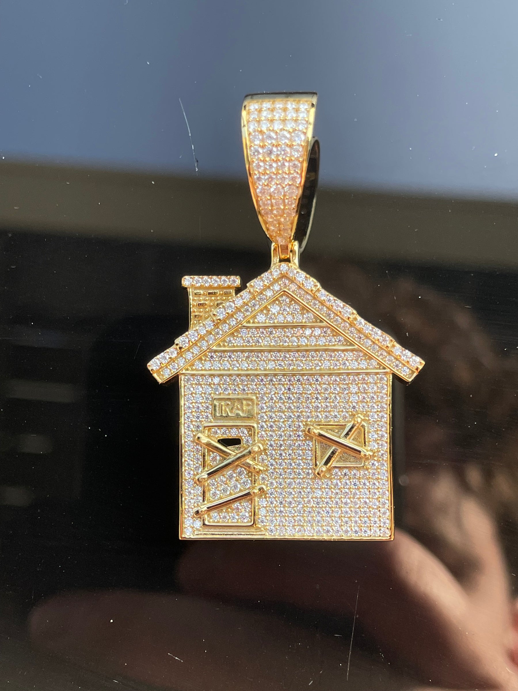 Front view of an 18K gold-plated S925 moissanite trap house pendant