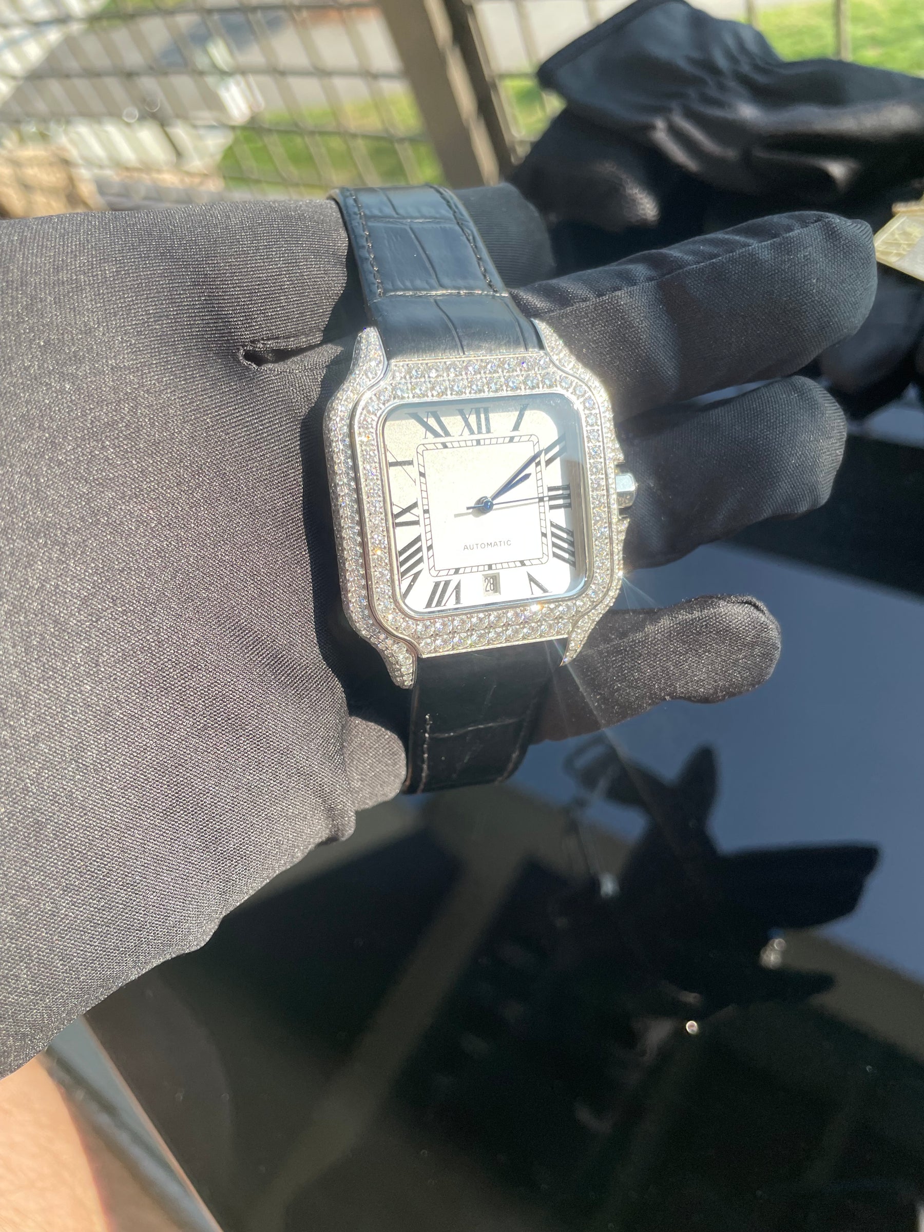 Front view of the silver-tone moissanite automatic watch and black leather strap