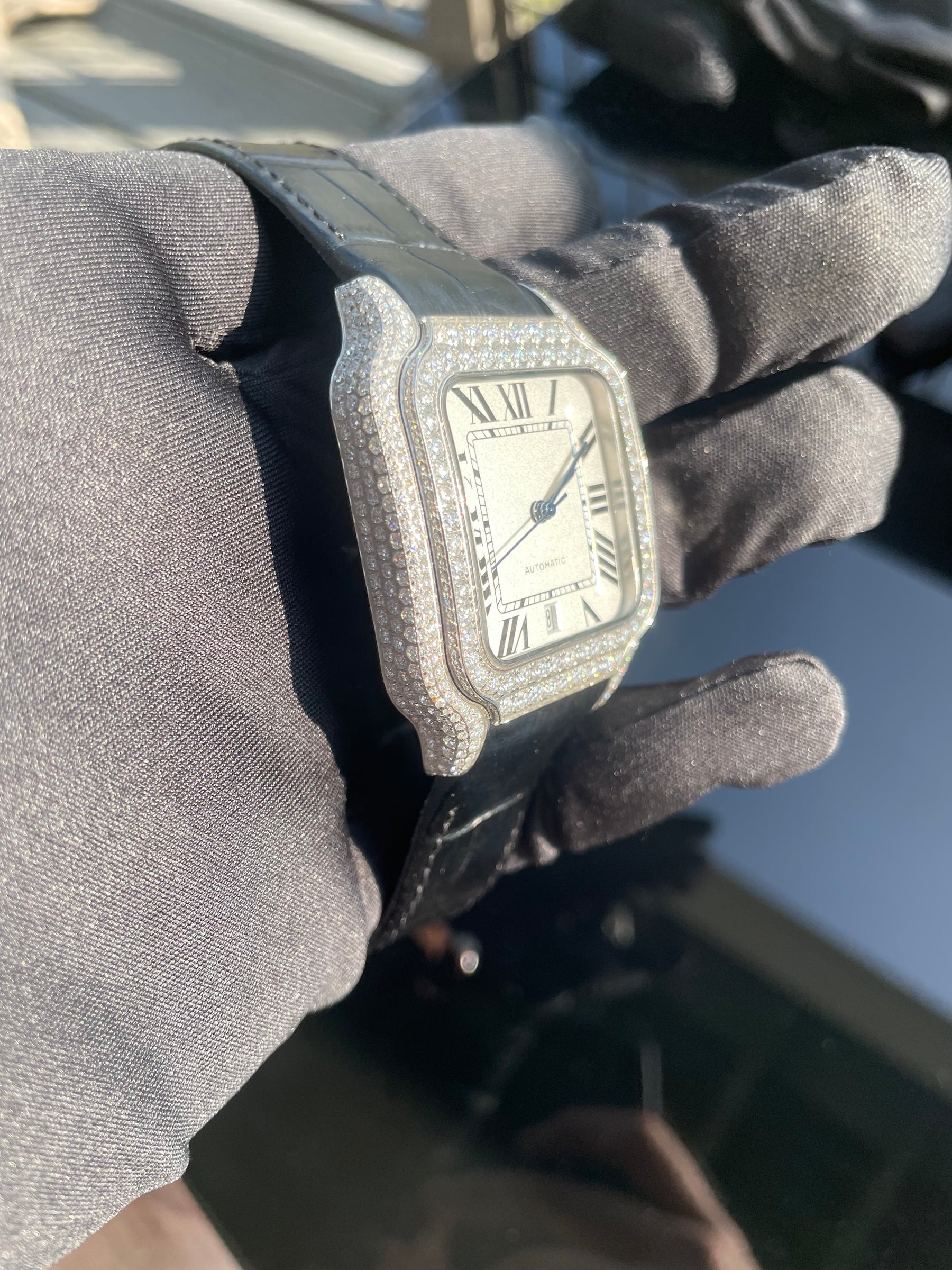 Angled close-up of the moissanite-set automatic watch case