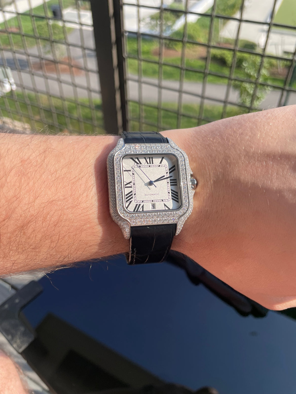 Moissanite automatic watch with Roman numeral dial worn on the wrist
