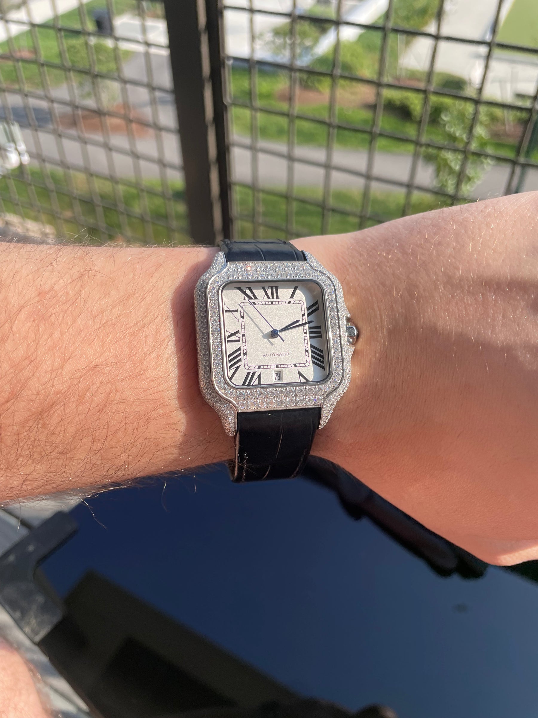 Moissanite automatic watch with Roman numeral dial worn on the wrist