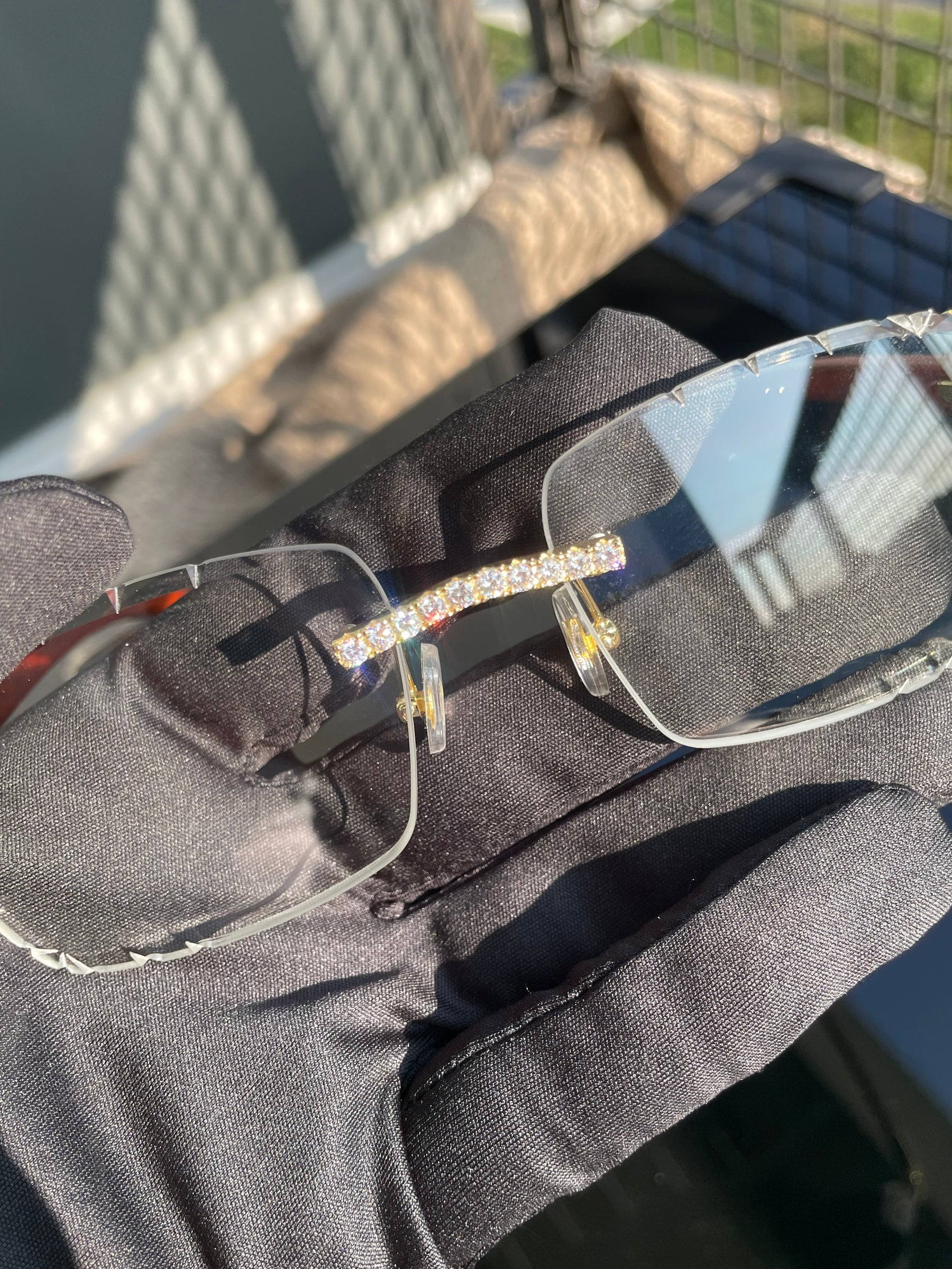 Close-up of the hand-set moissanite bridge on clear rimless glasses