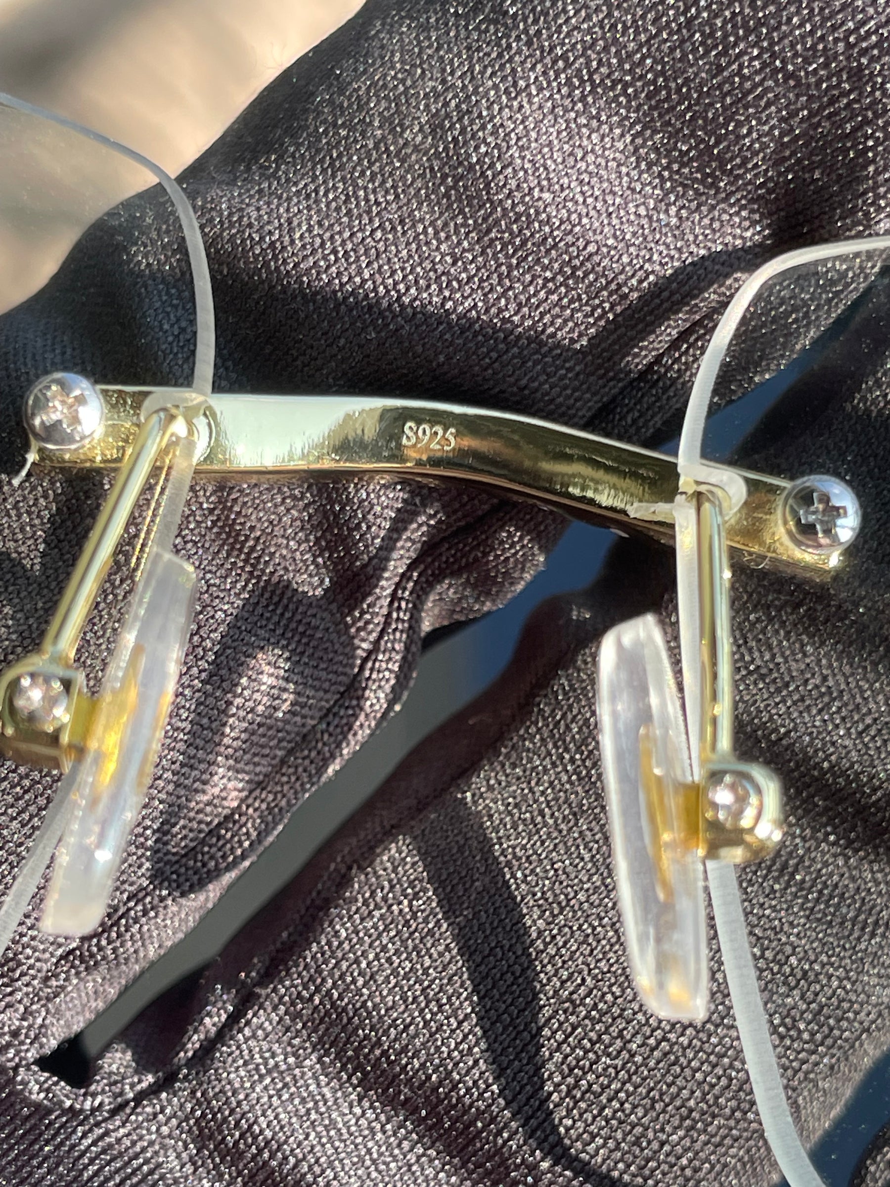 S925 stamp on the gold-tone bridge of the moissanite glasses