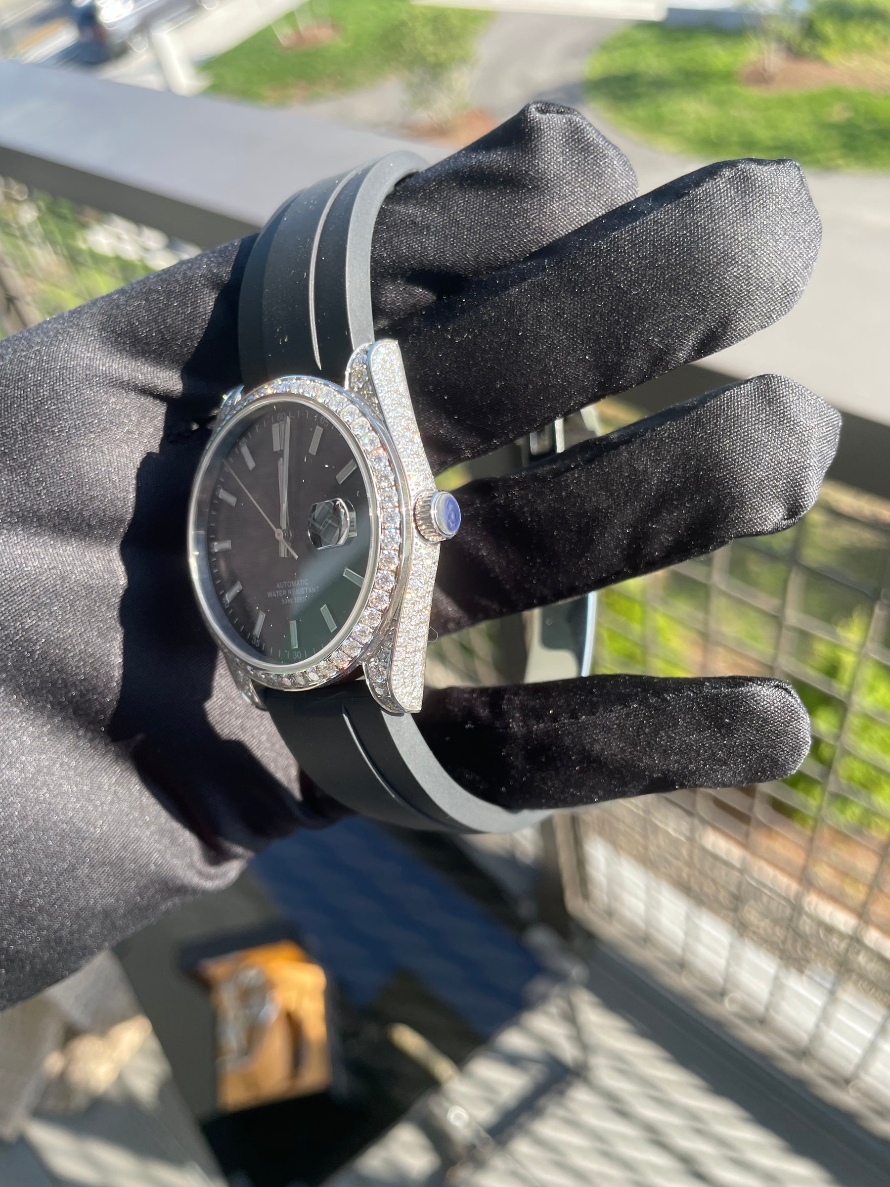 Side view of S1196S moissanite automatic watch with iced bezel and black rubber strap